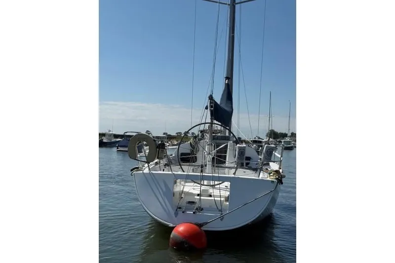 Slide: The Image of 2002 Beneteau First 36.7 sailboat docked in a marina, rear view. - 43