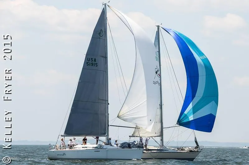 Slide: The Image of Sailboats racing on open water, featuring a 2002 Beneteau First 36.7 model. - 47