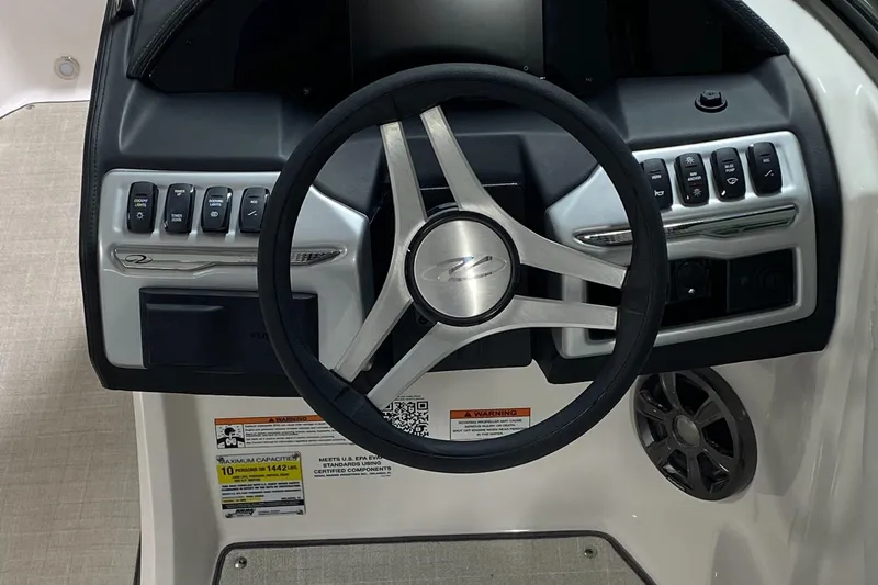 Slide: The Image of Steering wheel and dashboard of 2022 Regal 21 OBX boat, featuring control buttons and speaker. - 5