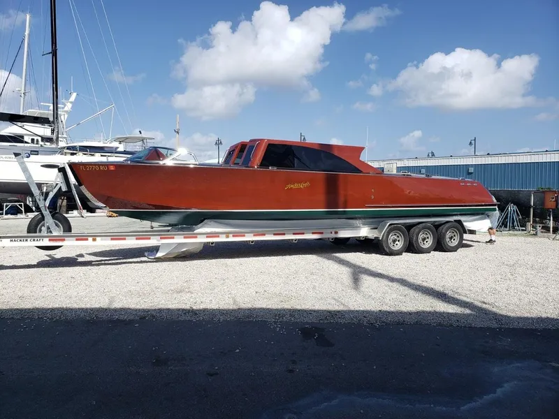Slide: The Image of 2019 Hacker-Craft 35 Sea Limo Commuter on trailer, under clear blue sky. - 3