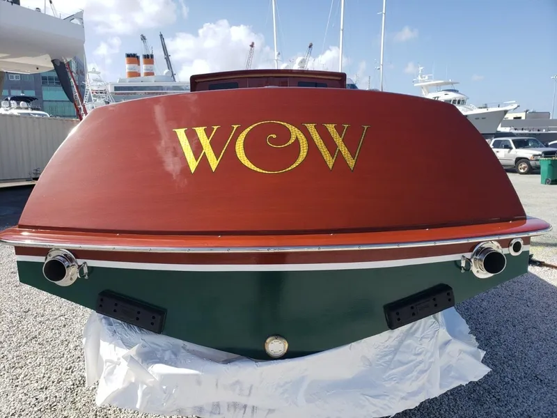 Slide: The Image of 2019 Hacker-Craft 35 Sea Limo Commuter boat with "WOW" on the stern, docked at a marina. - 4