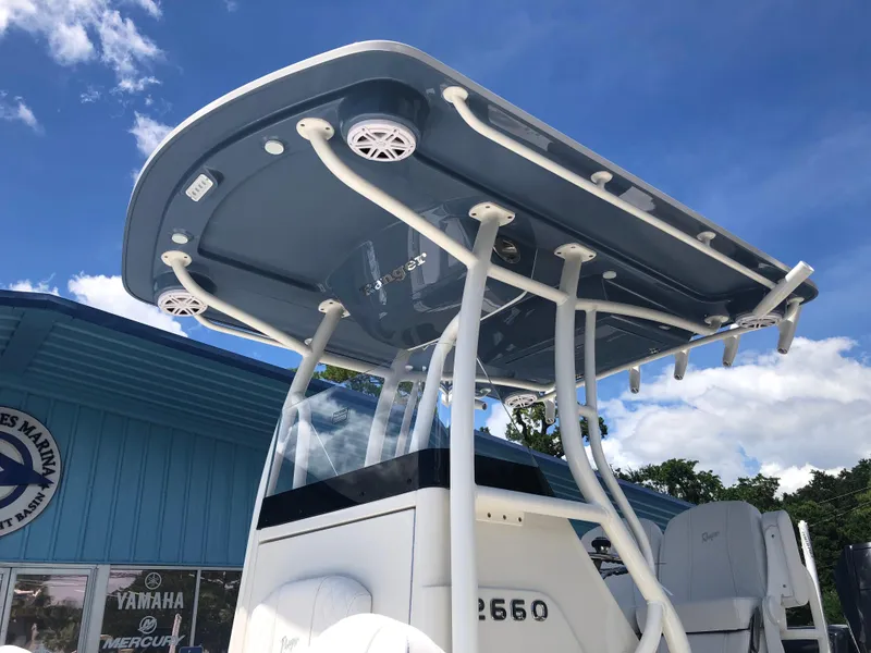Slide: The Image of Ranger 2660 boat, 2025 model, with T-top and speakers, against a blue sky backdrop. - 10