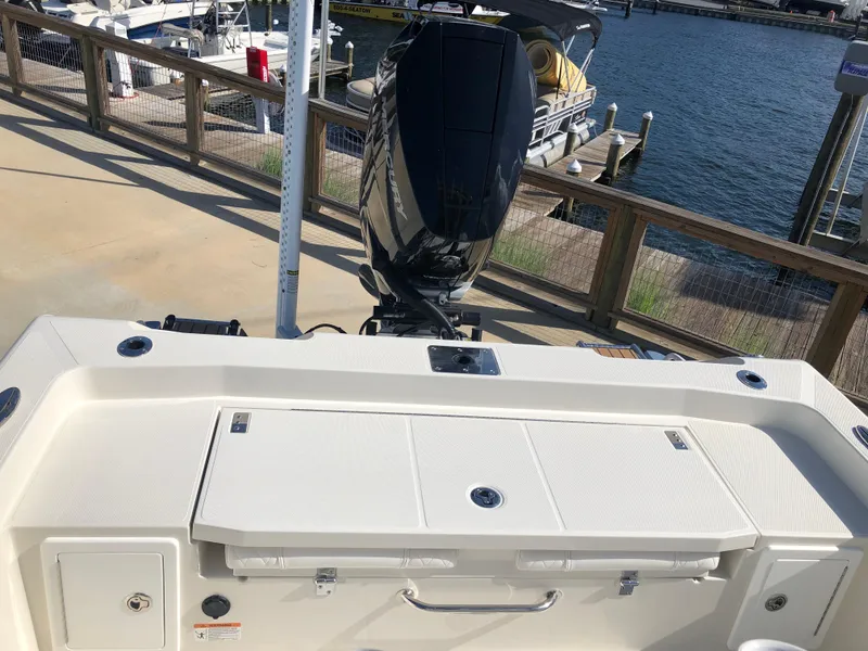 Slide: The Image of 2025 Ranger 2660 boat with powerful outboard motor at marina dock. - 18