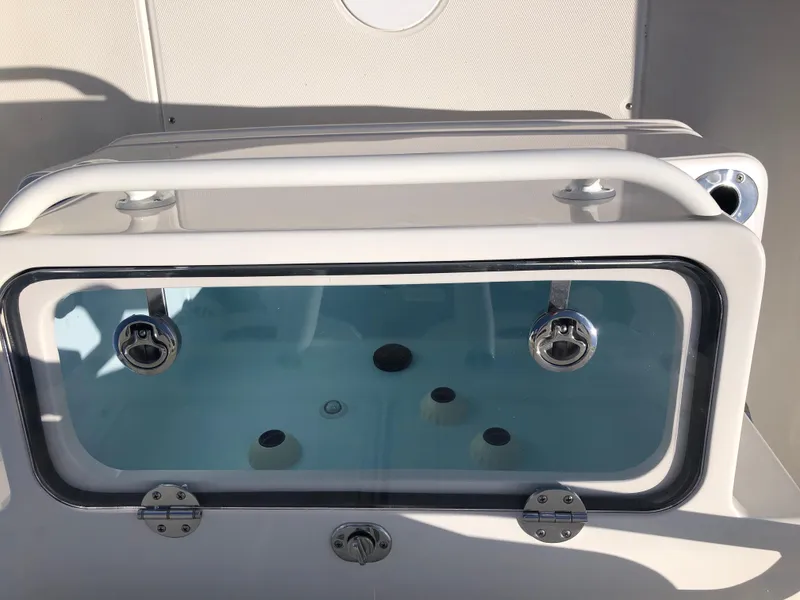 Slide: The Image of Ranger 2660 boat livewell, 2025 model, with clear viewing window and secure latches. - 24