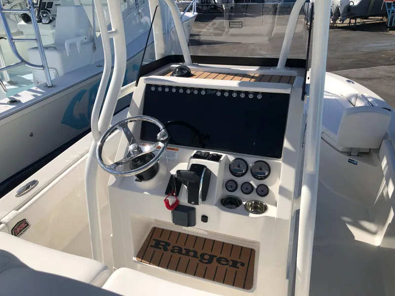 Slide: The Image of Ranger 2660 boat dashboard, 2025 model, featuring steering wheel and control panel. - 25