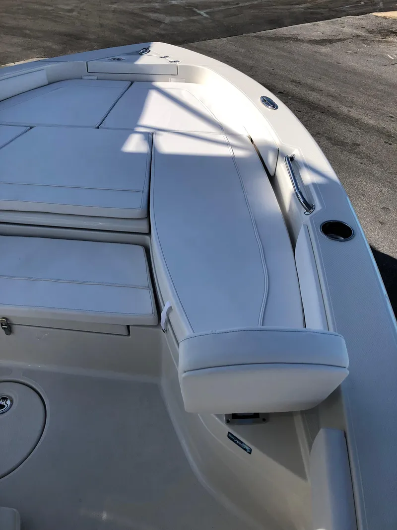 Slide: The Image of 2025 Ranger 2660 boat interior with white cushioned seating and sleek design. - 31