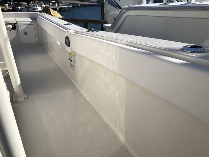 Slide: The Image of 2025 Ranger 2660 boat interior, featuring sleek white deck and side paneling. - 36
