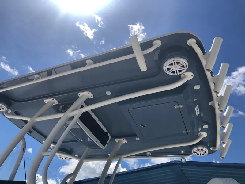 Slide: The Image of Ranger 2660 boat roof with rod holders and speakers, 2025 model, under clear blue sky. - 9