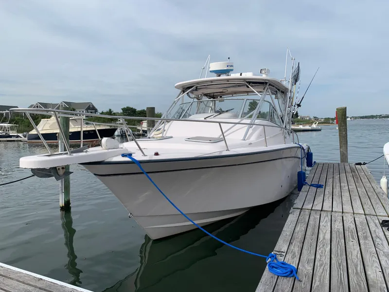 The Image of 2001 Grady-White 330 Express boat docked at marina, clear sky background. - 1