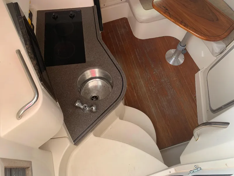 Slide: The Image of 2001 Grady-White 330 Express boat interior with kitchenette and seating area. - 10