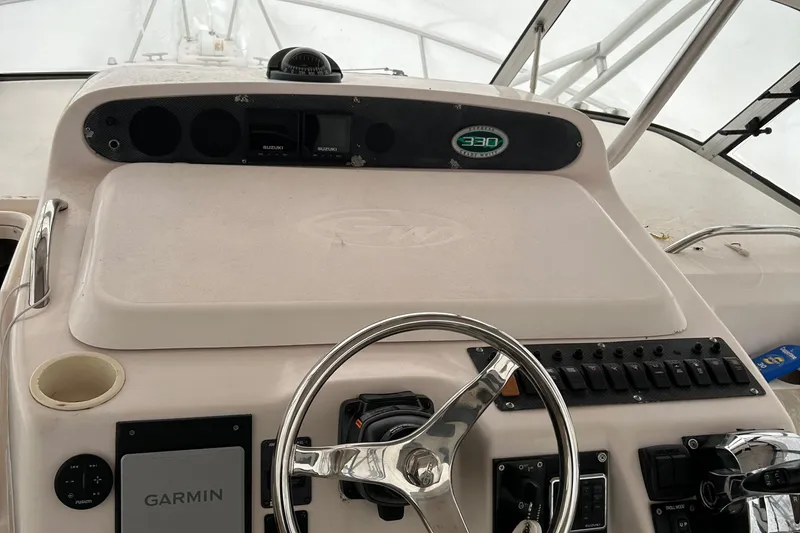Slide: The Image of 2001 Grady-White 330 Express boat helm with Garmin navigation system. - 12