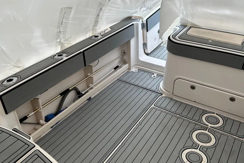 Slide: The Image of 2001 Grady-White 330 Express boat interior with storage compartments and non-slip flooring. - 13