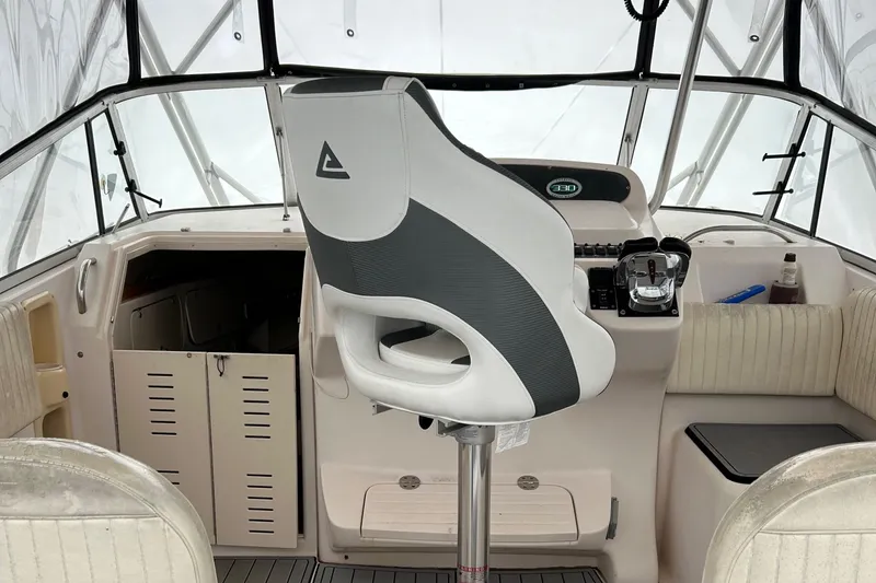 Slide: The Image of Cockpit of 2001 Grady-White 330 Express boat with captain's chair and control panel. - 15
