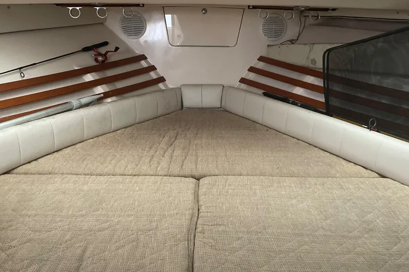 Slide: The Image of Interior cabin of a 2001 Grady-White 330 Express boat with beige cushions. - 16