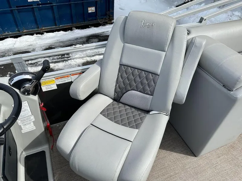 Slide: The Image of 2021 Ranger 243C boat captain's chair with diamond-stitched upholstery. - 2