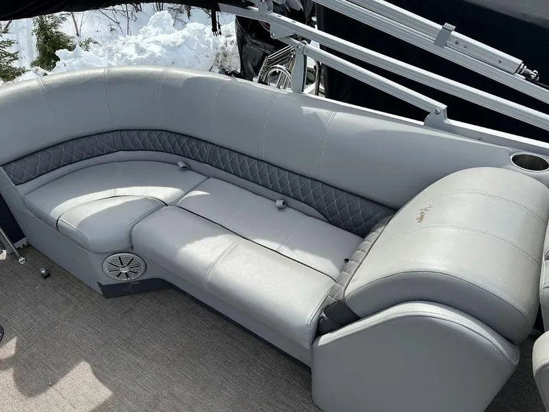 Slide: The Image of 2021 Ranger 243C boat with gray cushioned seating and cup holder. - 3