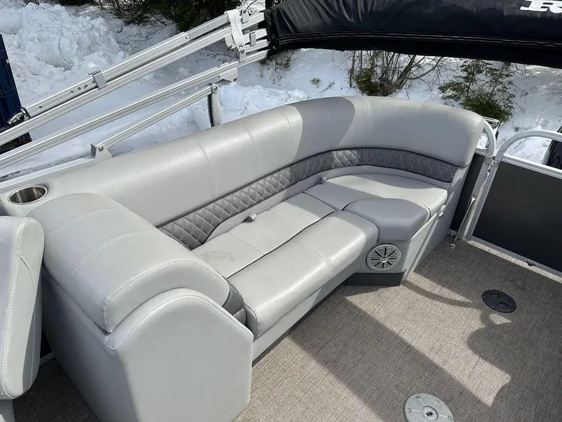 Slide: The Image of 2021 Ranger 243C pontoon boat with gray leather seating and cup holder. - 4