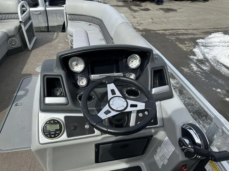 Slide: The Image of 2021 Ranger 243C boat dashboard with steering wheel and gauges. - 8