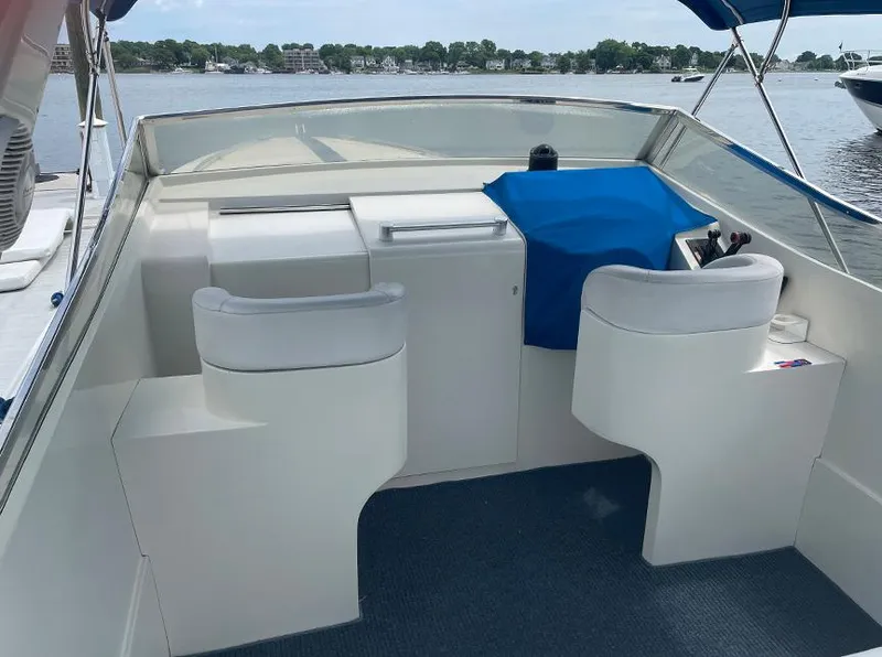 Slide: The Image of Custom 42 boat interior, 1999 model, featuring helm station and seating, docked on a calm lake. - 11