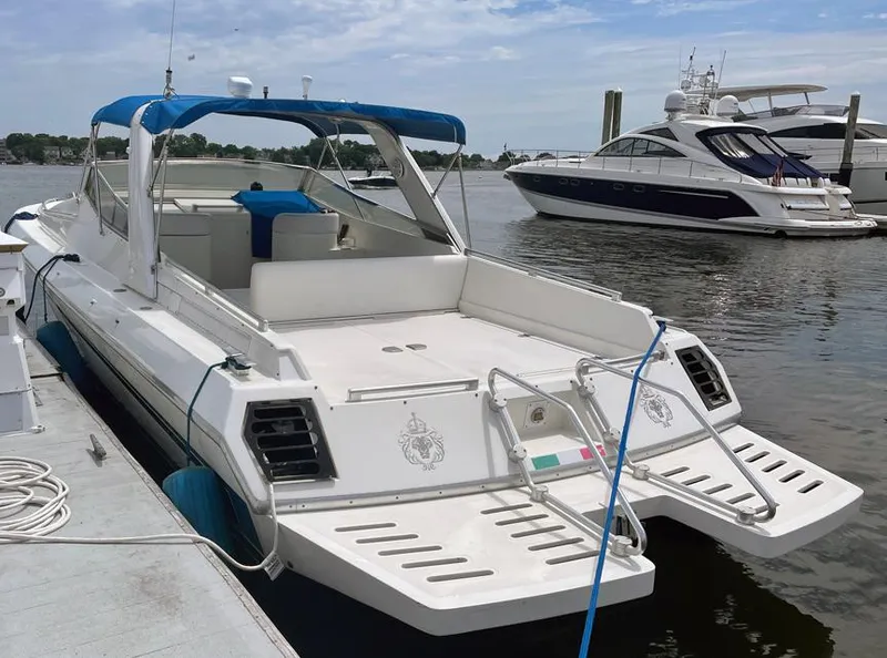 Slide: The Image of Custom 42 1999 boat docked at marina with blue canopy. - 2