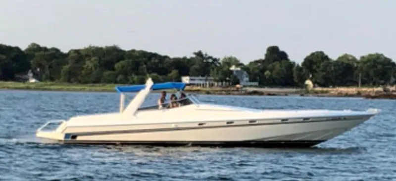 Slide: The Image of Custom 42 boat from 1999 cruising on a scenic lake. - 3