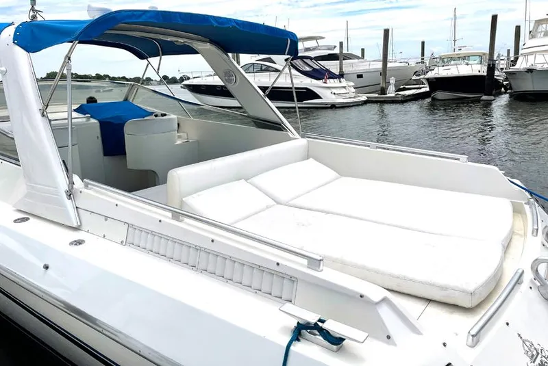 Slide: The Image of Custom 42 1999 yacht with blue canopy docked at marina. - 7