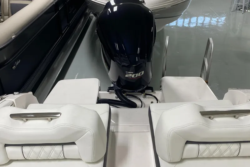 Slide: The Image of 2022 Regal LX2 boat with Yamaha 200 engine, featuring white cushioned seating. - 4