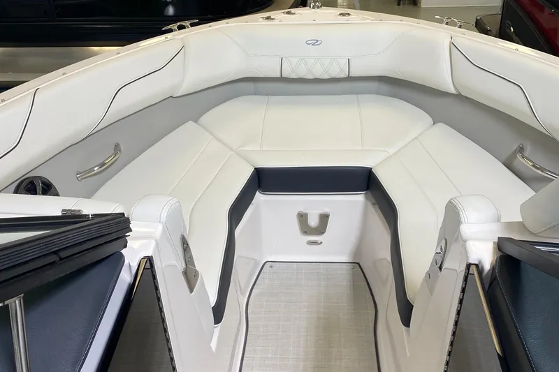 Slide: The Image of 2022 Regal LX2 boat interior with white cushioned seating and sleek design. - 6