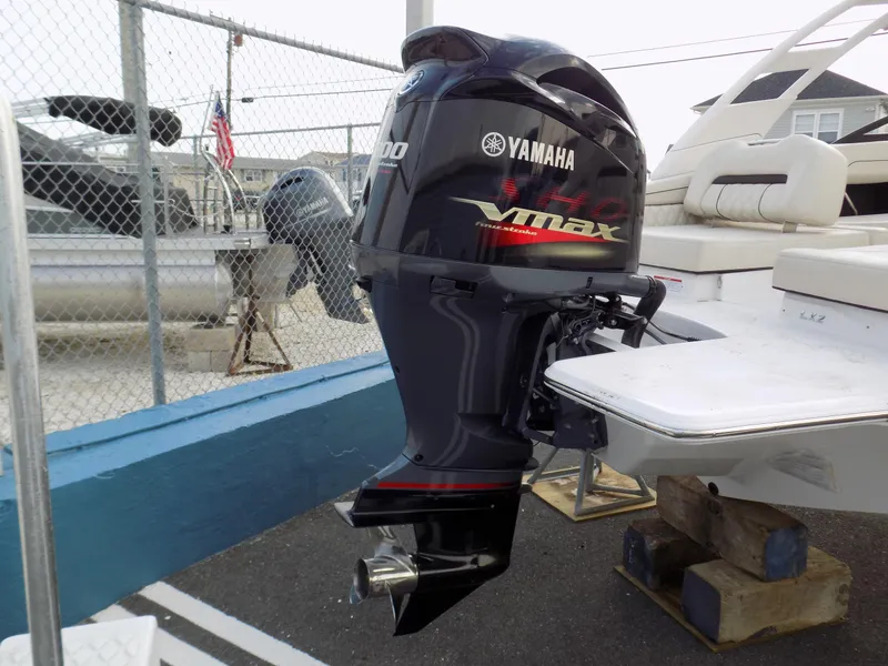 Slide: The Image of Yamaha VMAX outboard motor on 2022 Regal LX2 boat, docked near a fence. - 8