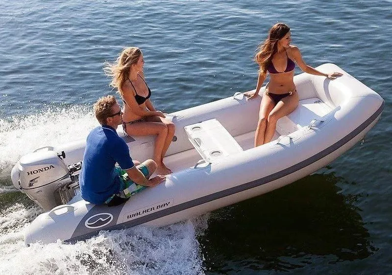 Slide: The Image of 2023 Walker Bay Supertender 325 Deluxe on water with three passengers. - 4