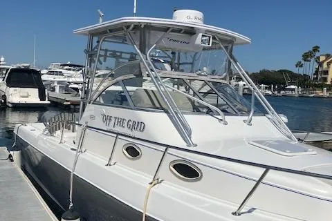 Slide: The Image of 2004 Pro-Line 30 WALK boat docked at marina, clear sky, calm water. - 3