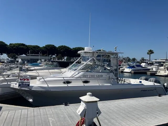 Slide: The Image of 2004 Pro-Line 30 WALK boat docked at marina under clear blue sky. - 30