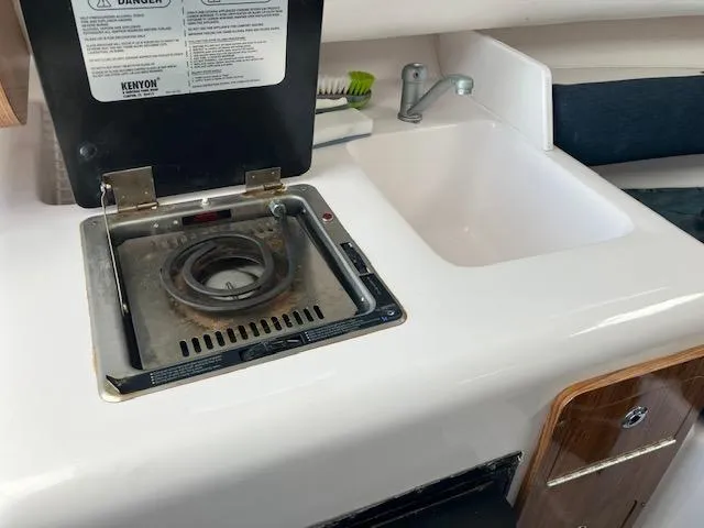 Slide: The Image of 2004 Pro-Line 30 WALK boat kitchenette with stove and sink. - 6