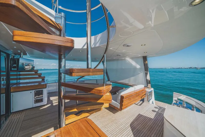 Slide: The Image of Azimut Magellano 25 Metri 2023 yacht deck with spiral staircase and ocean view. - 18