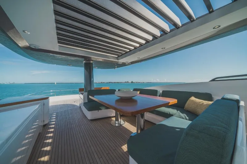 Slide: The Image of Azimut Magellano 25 Metri 2023 yacht deck with ocean view, modern seating, and wooden table. - 39