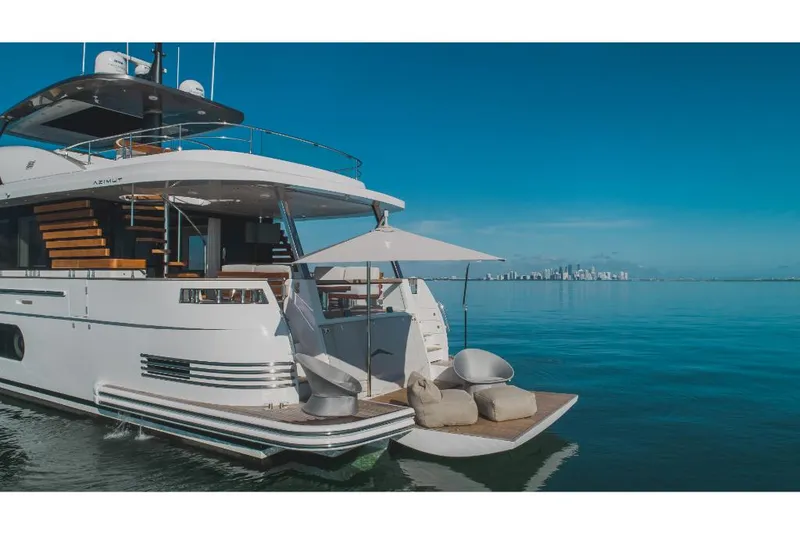 Slide: The Image of 2023 Azimut Magellano 25 Metri luxury yacht on calm waters with city skyline. - 9