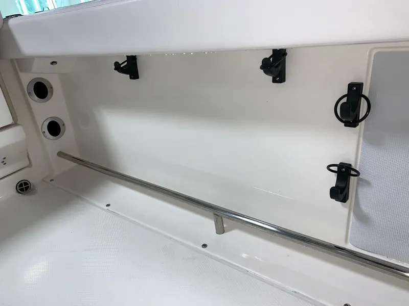 Slide: The Image of 2026 Robalo R222 Center Console interior with rod holders and storage compartments. - 14