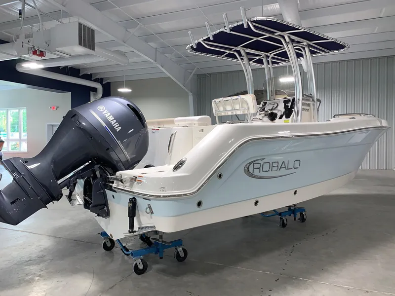 Slide: The Image of 2026 Robalo R222 Center Console boat with Yamaha engine in showroom. - 2