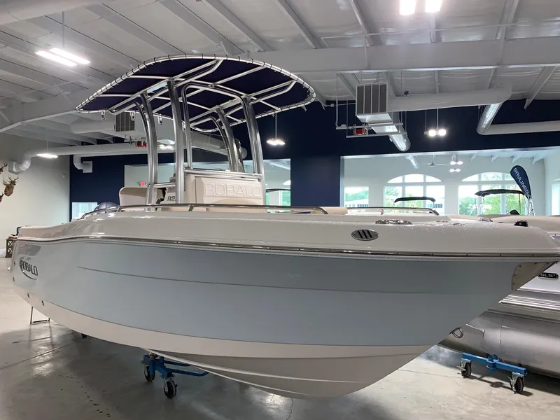 Slide: The Image of 2026 Robalo R222 Center Console boat displayed indoors, showcasing sleek design and modern features. - 4