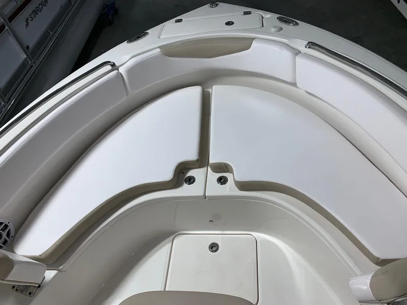 Slide: The Image of 2026 Robalo R222 Center Console boat with white cushioned seating area. - 22