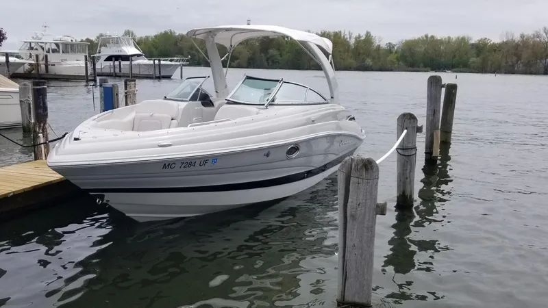 Slide: The Image of 2018 Crownline 275 SS boat docked on a calm lake. - 4