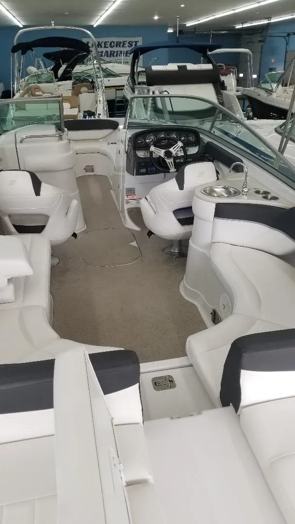 Slide: The Image of 2018 Crownline 275 SS boat interior with white seating and modern dashboard. - 7