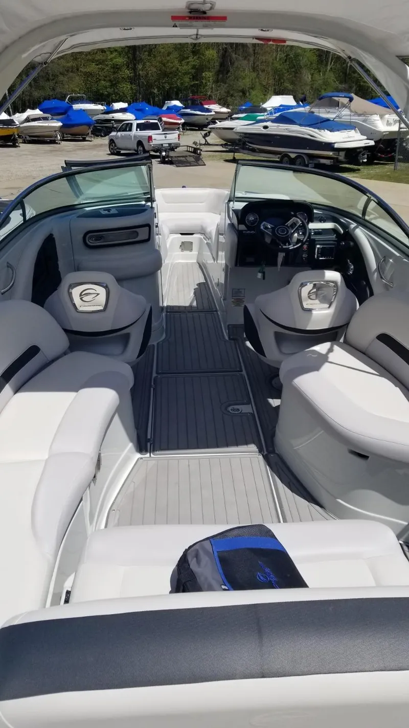 Slide: The Image of 2018 Crownline 275 SS boat interior with sleek seating and modern dashboard. - 8