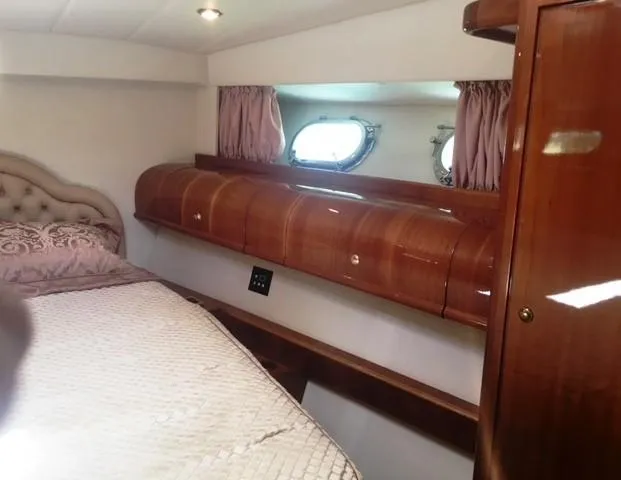 Slide: The Image of Luxurious 1997 Baia Cantieri yacht cabin with elegant wood finish and cozy bedding. - 11