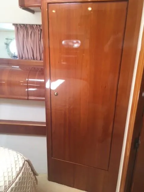 Slide: The Image of 1997 Baia Cantieri yacht interior with wooden cabinetry and cozy bedroom. - 12