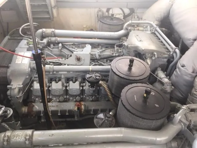 Slide: The Image of Engine room of a 1997 Baia Cantieri boat, showcasing complex machinery and components. - 13