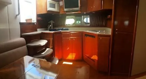 Slide: The Image of Luxurious 1997 Baia Cantieri yacht interior with modern kitchen and wooden cabinetry. - 5