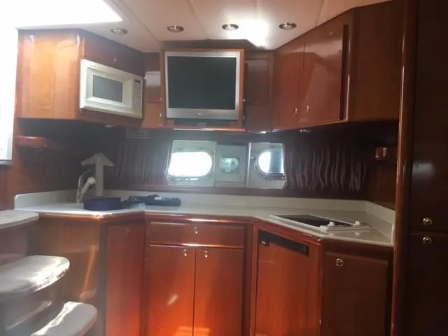 Slide: The Image of Luxurious 1997 Baia Cantieri yacht interior with kitchen and entertainment area. - 6