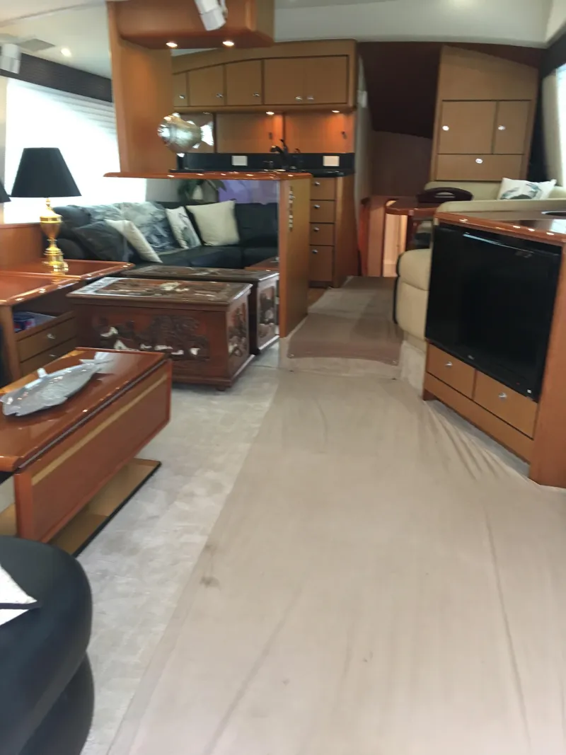 Slide: The Image of Interior of 2001 Ocean Yachts 56 Super Sport, featuring luxurious seating and elegant wood finishes. - 13