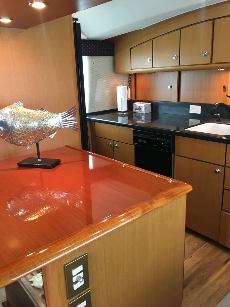 Slide: The Image of Luxurious kitchen interior of 2001 Ocean Yachts 56 Super Sport with wood cabinetry. - 14